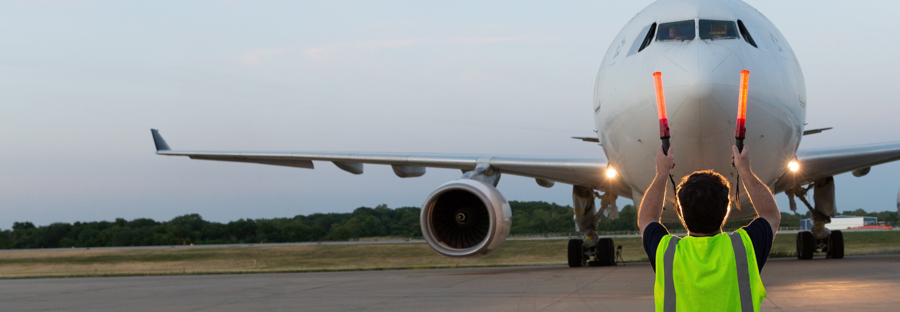 Controller directing a plane on a runway