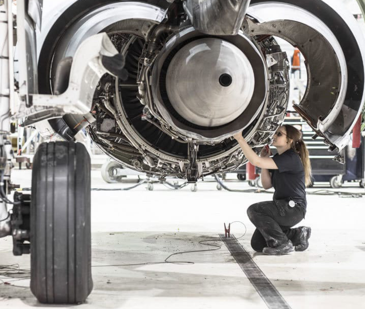 Female technician working on aircraft