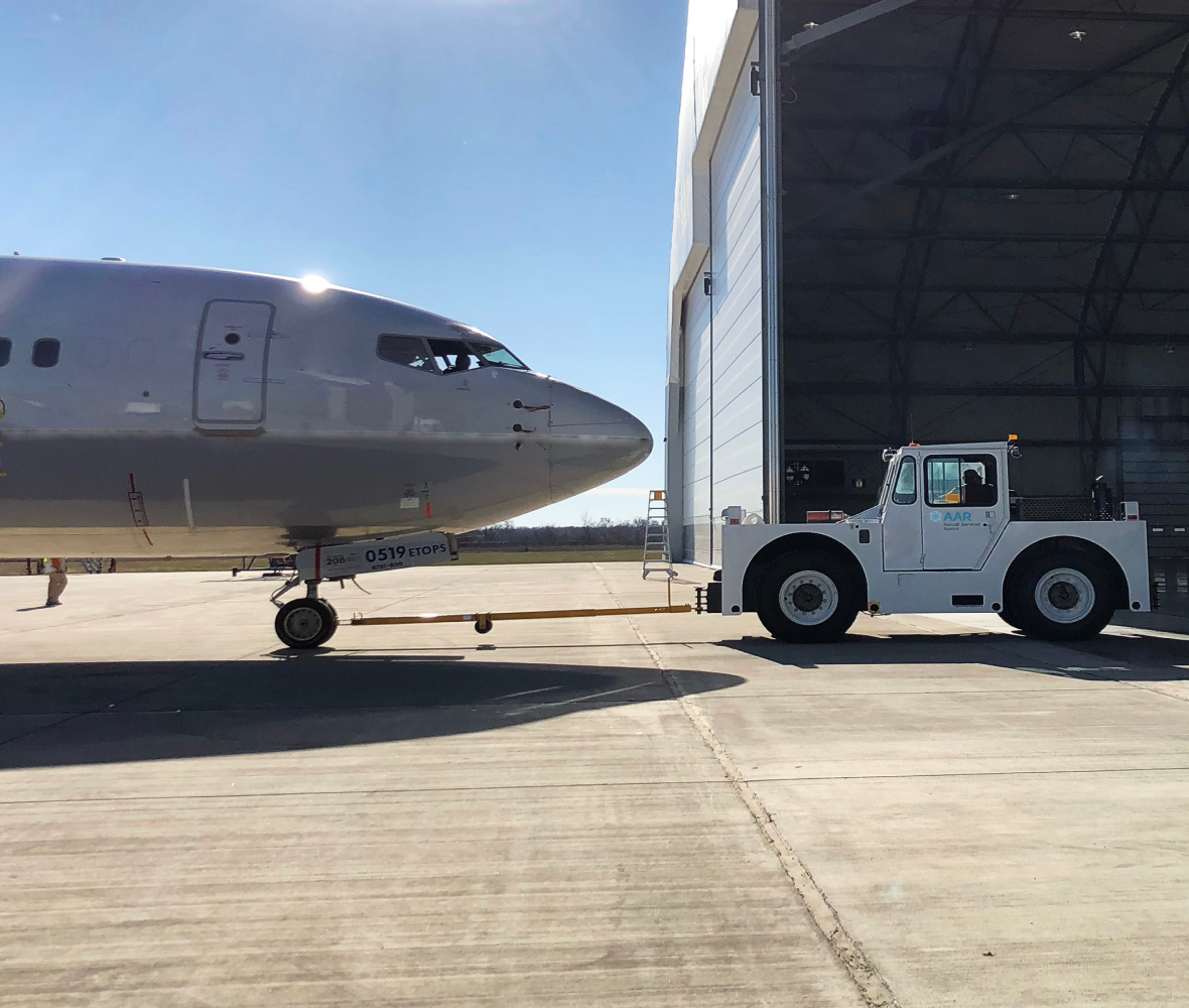 Truck pulling an airplane into a hangar Truck pulling an airplane into a hangar