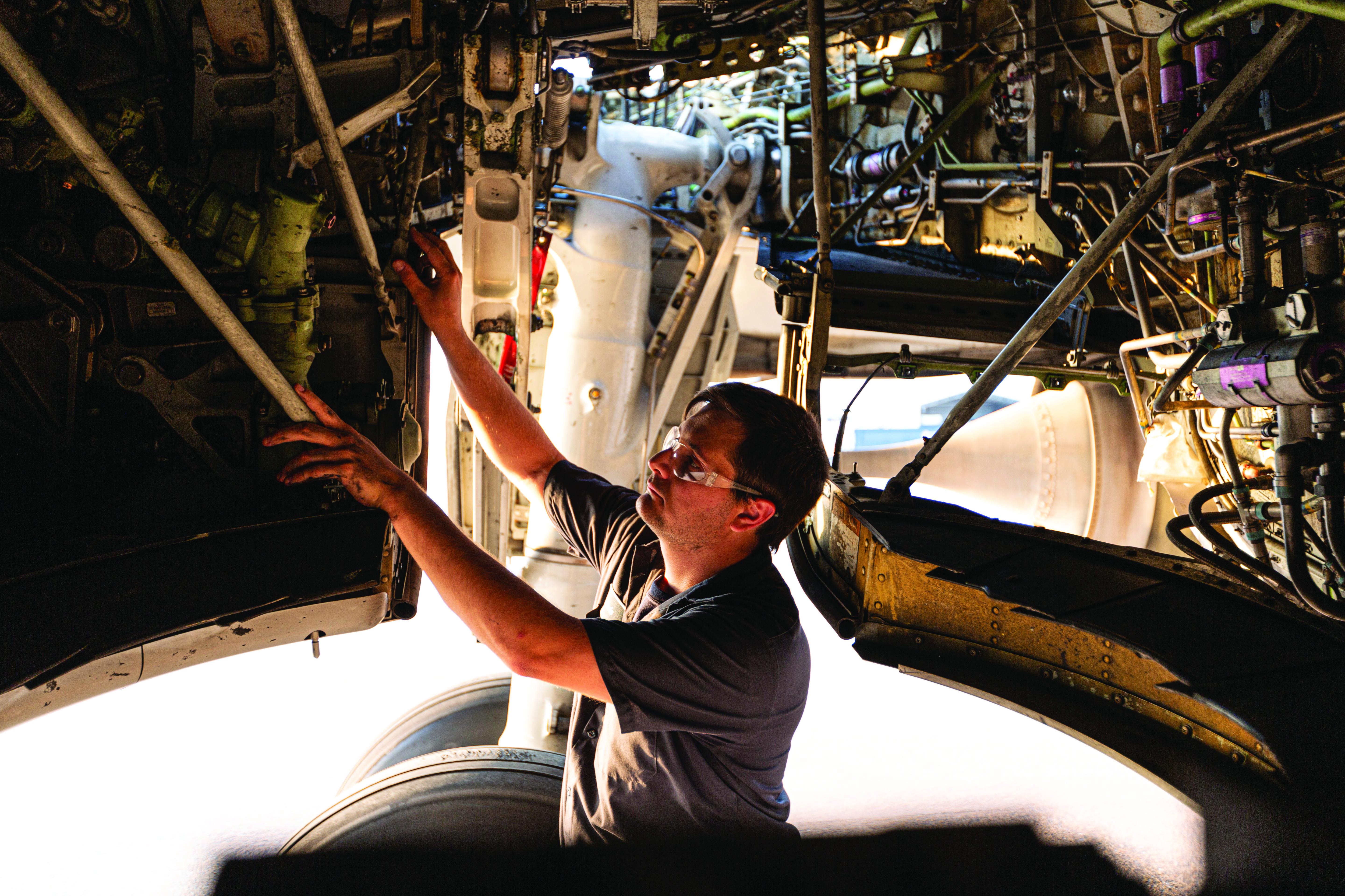 Male technician working on a plane