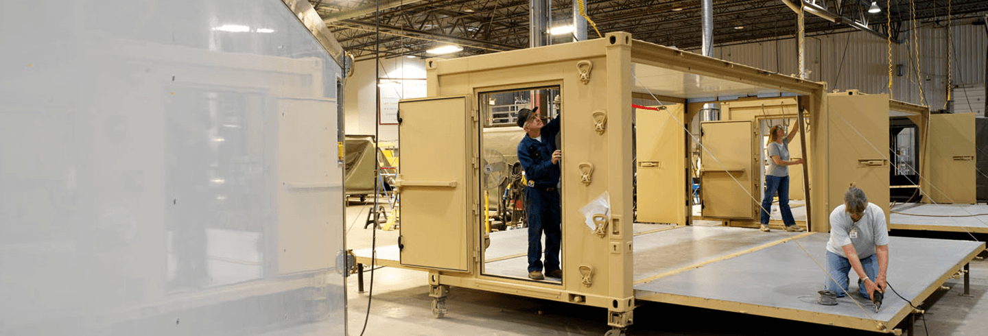 Mobility systems employees working in a hangar