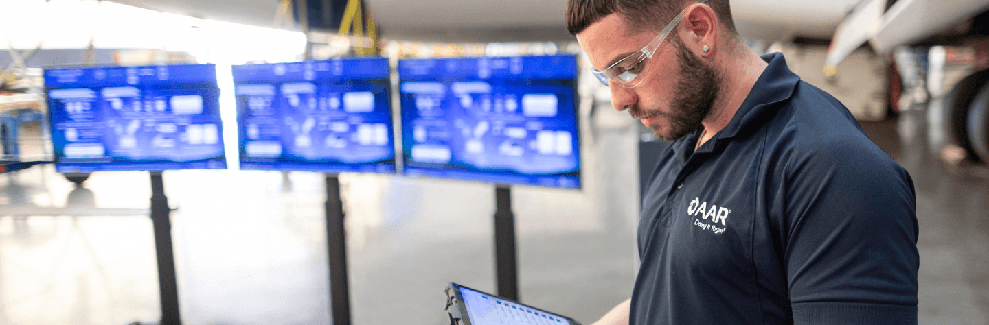 AAR employee in front of monitors