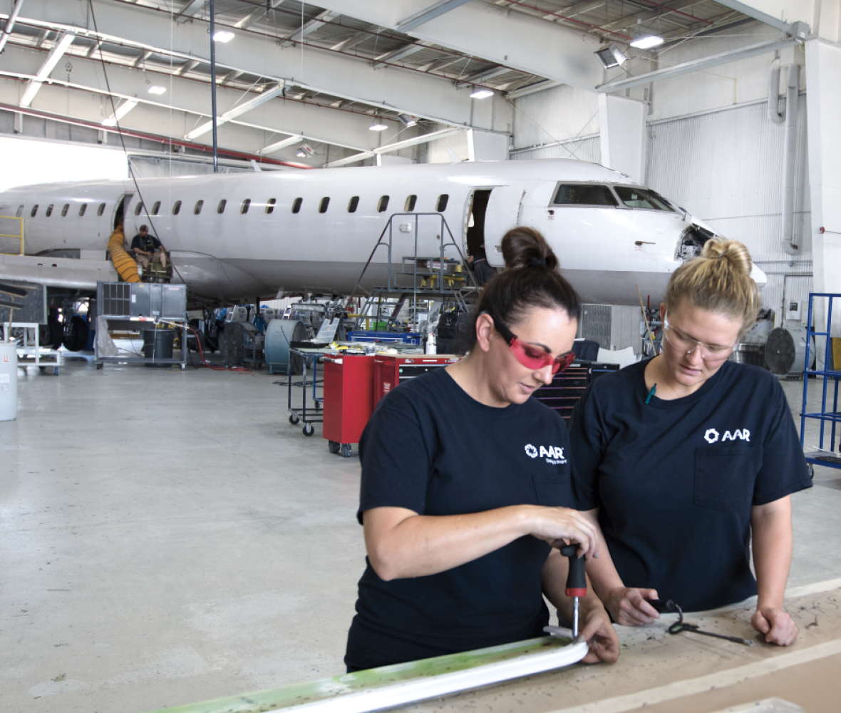 Two colleagues working together in front of an airplane Two colleagues working together in front of an airplane